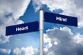 Street sign in front of cloudy sky representing choice between listening to the Ã¢â¬ËheartÃ¢â¬â¢ or the Ã¢â¬Ëmind` Royalty Free Stock Photo